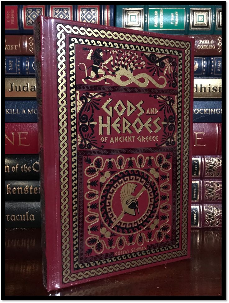 a red book sitting on top of a wooden table next to many bookshelves