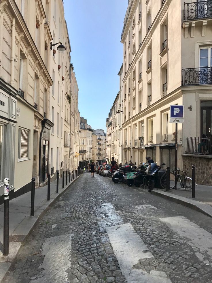 an empty street with cars parked on the side