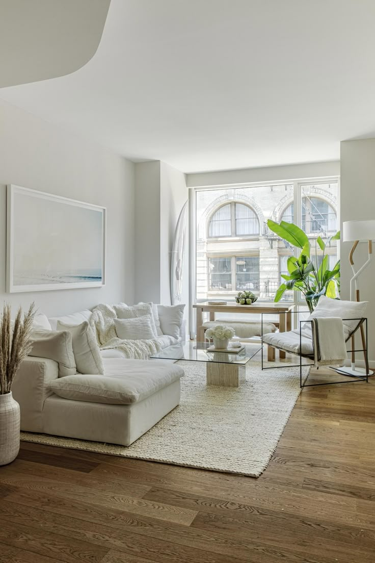 a living room filled with furniture and a large window