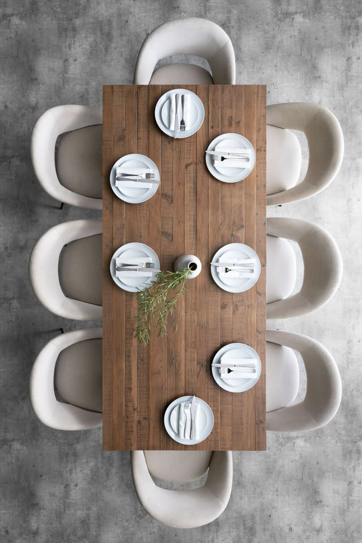 an overhead view of a dining table with plates and utensils on the top