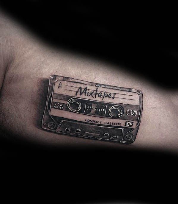 a man's arm with an old school style cassette tattoo on the left side