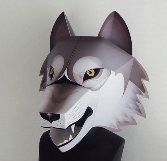 a paper mask with an image of a wolf on it's face and yellow eyes