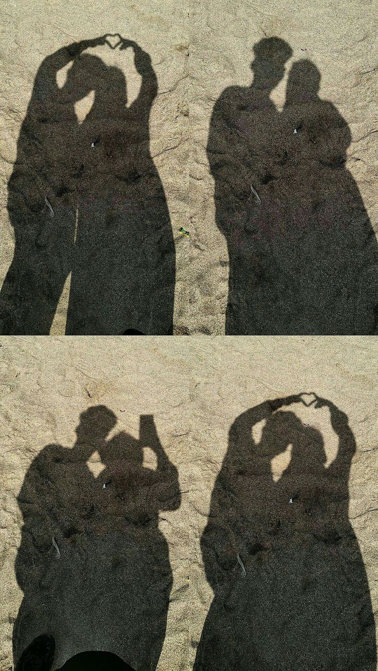 the shadow of two people standing next to each other with their hands on their heads