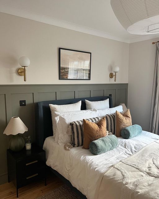 a bed with white sheets and pillows in a room