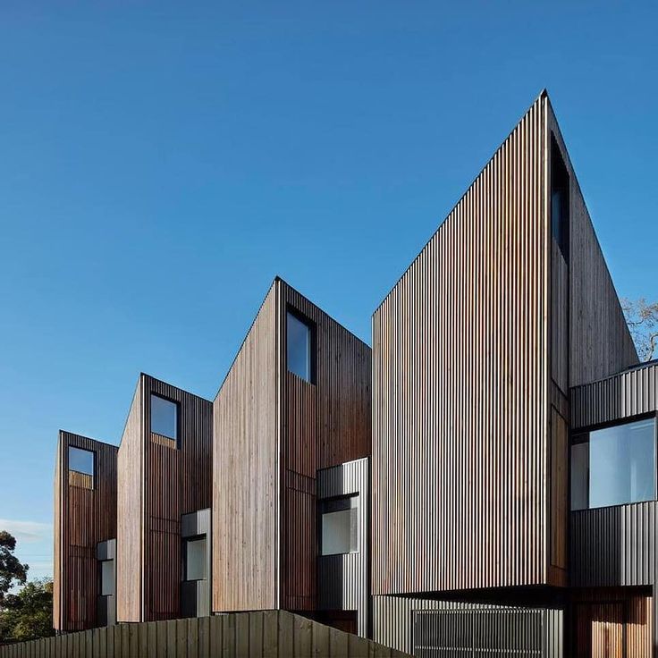 three wooden buildings with windows on each side