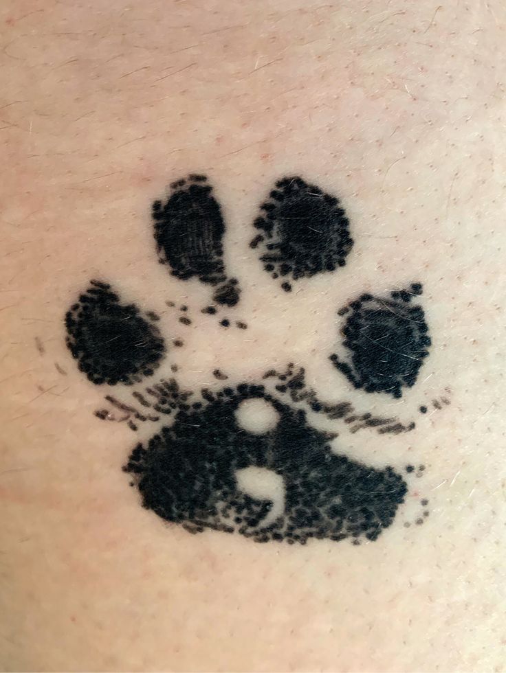 an animal's paw print is shown on the back of a person's arm