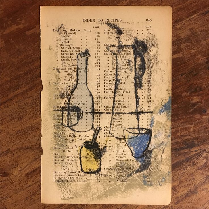 an old book with some bottles and beakers on it, sitting on a table