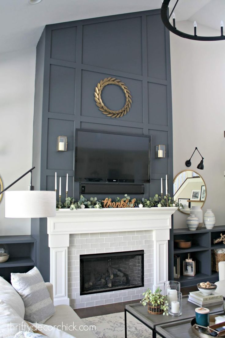 a living room filled with furniture and a fire place in front of a flat screen tv