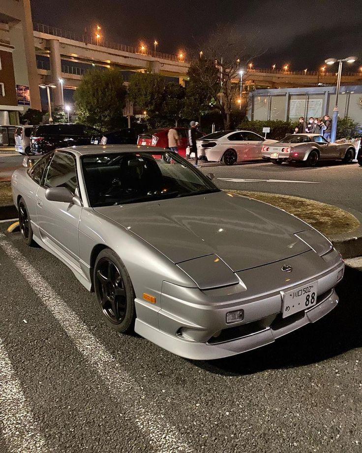 a silver sports car parked in the parking lot