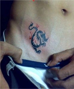 a man with a dragon tattoo on his stomach is cutting into the side of his belly