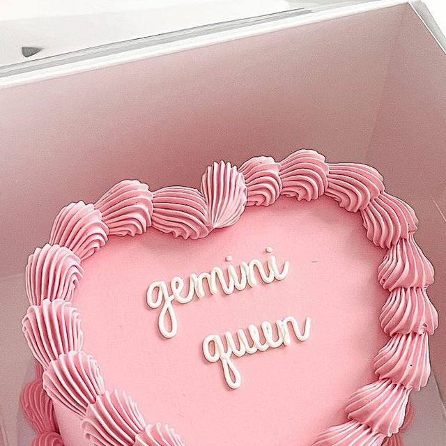 a pink heart shaped cake in a box with the words going gummy on it