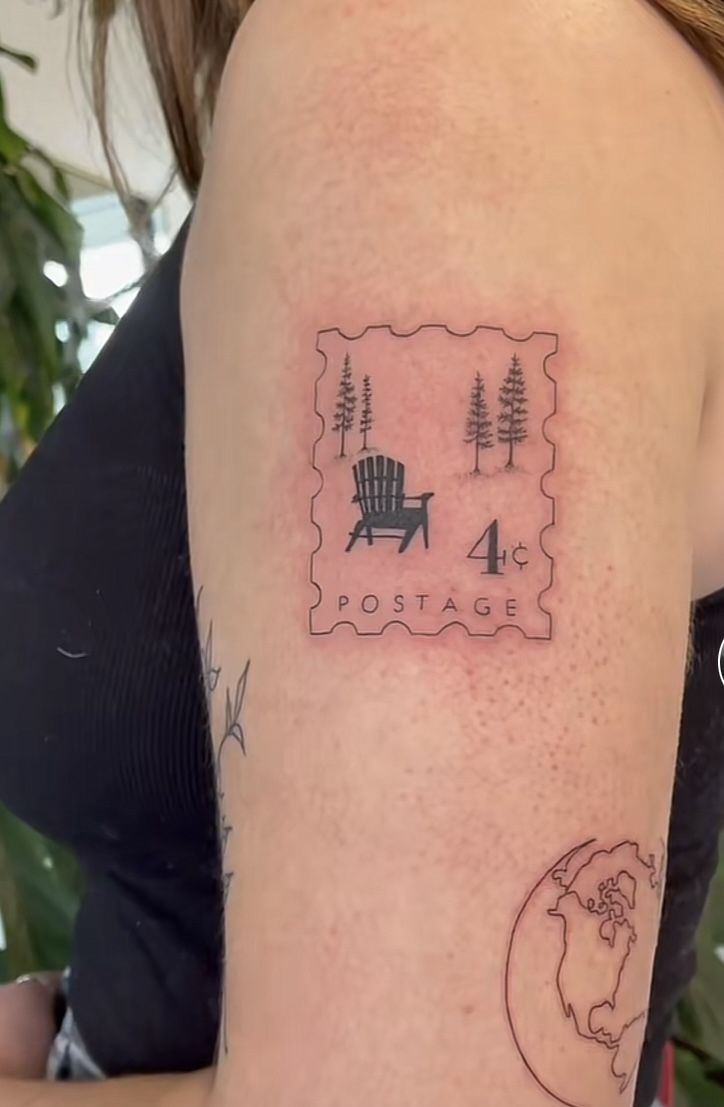 a woman's arm with a stamp on it and a chair in the background