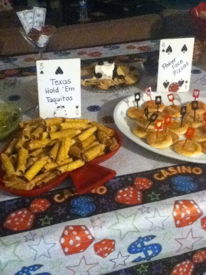 several plates of food on a table with cards and other items for sale in front of them