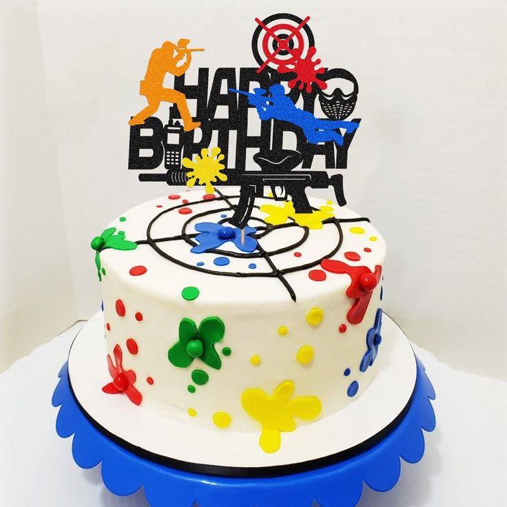 a birthday cake decorated with colorful paint splatters