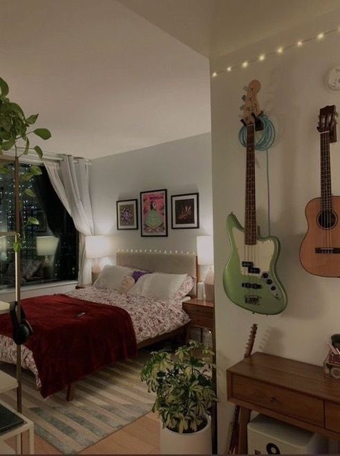 a bedroom with guitars hanging on the wall