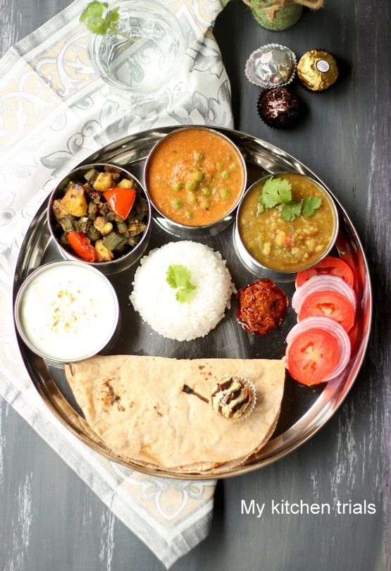 a metal plate topped with lots of different types of food on top of a table