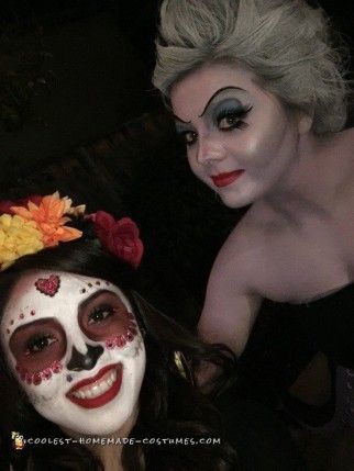 two women with face paint and flowers on their heads