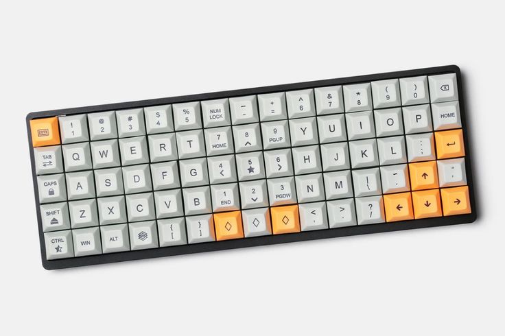 an orange and white keyboard is shown on a gray surface with the letters below it