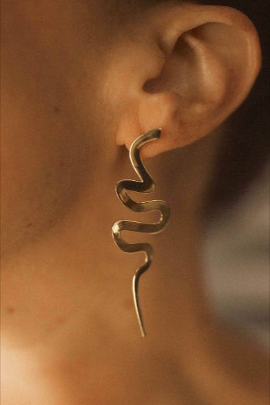 Make a statement in these swirling, snake-like earrings that drip from your ears like ribbons of cascading water. Lightweight but impactful, these modern Medusa earrings catch the light in the most elegant, seductive way. Spiral Single Earring For Party, Snake Shape Earrings For Party, Elegant Snake Shape Earrings With Ear Wire, Modern Medusa, Medusa Earrings, Ribbon Earrings, Snake Jewelry, The Light, Favorite Jewelry