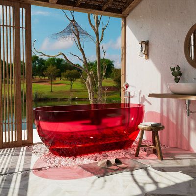 a red bathtub sitting in the middle of a bathroom next to a sink and window