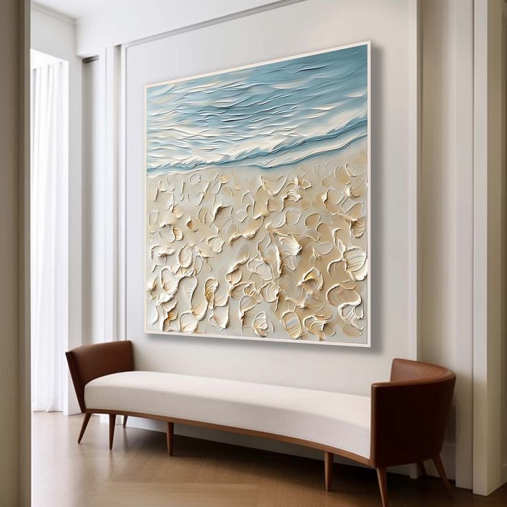 an abstract painting hangs on the wall above a white bench in front of a window