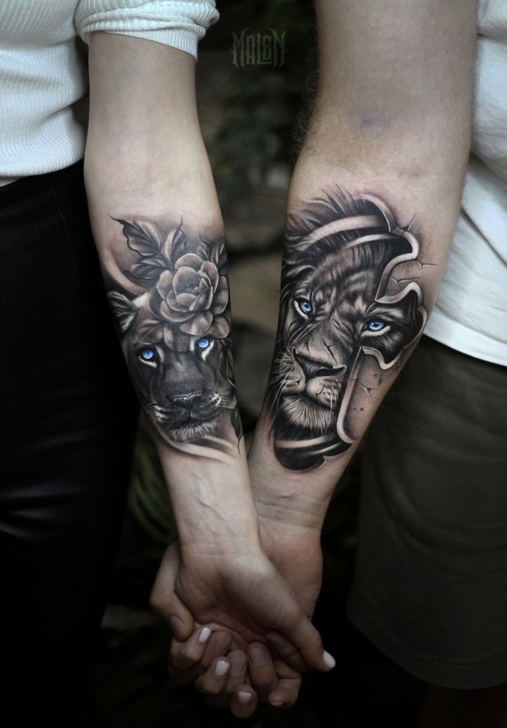 two people holding hands with tattoos on them