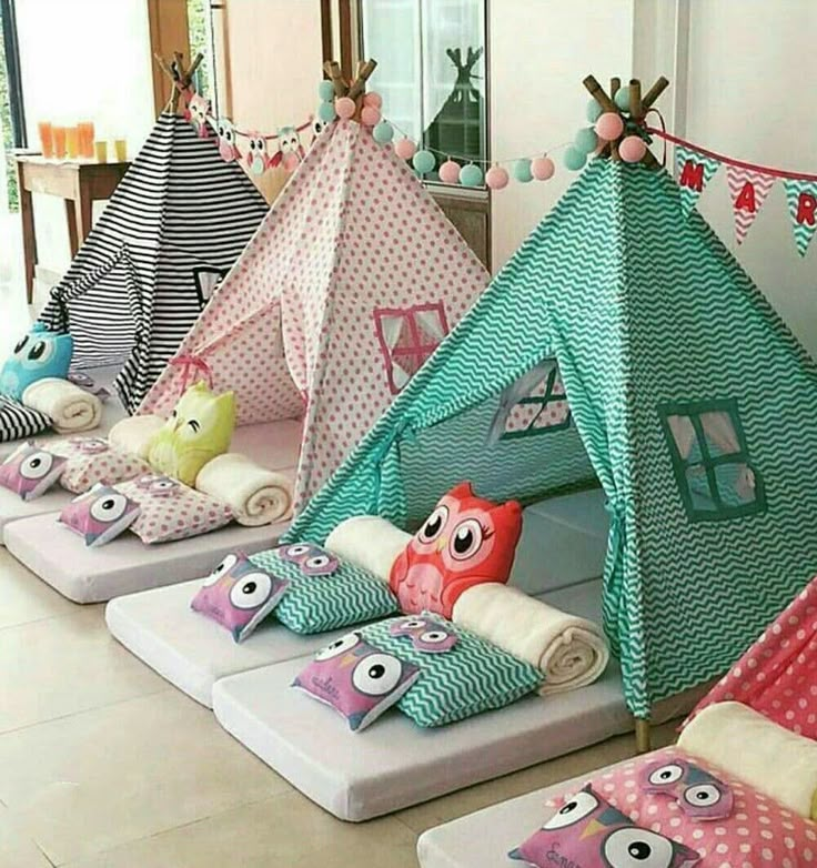 a group of kids's teepees with different designs and colors on them