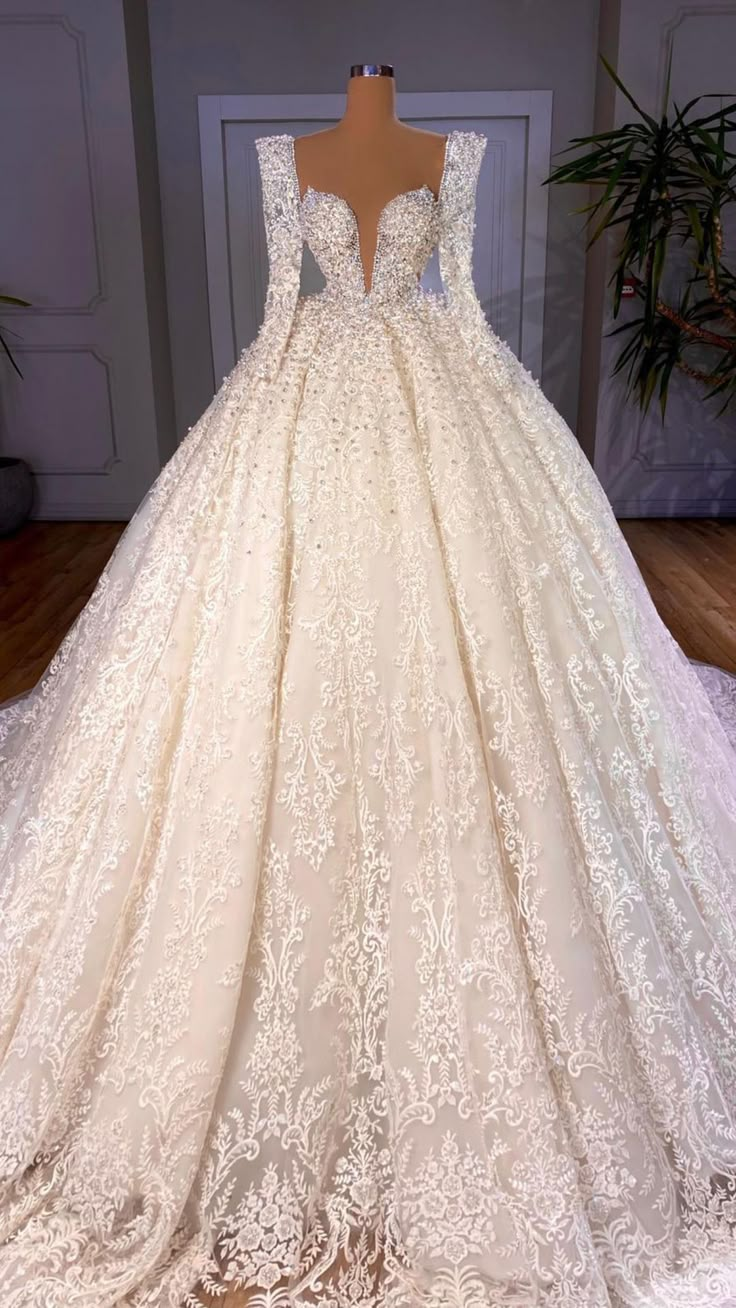 a wedding dress on display in front of a door