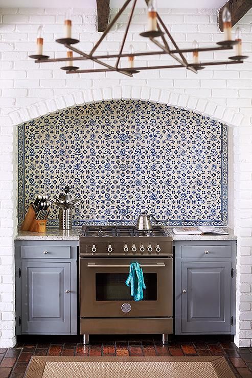 a kitchen with an oven, stove and rug