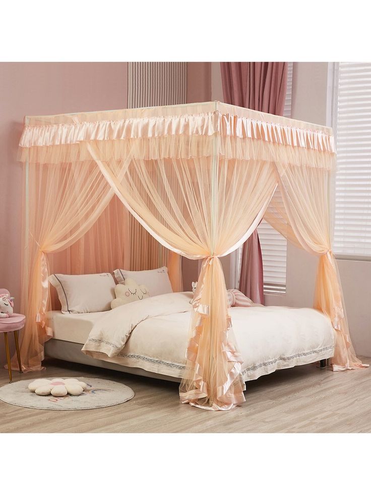 a canopy bed with sheer curtains and pillows on the bottom side, in a pink bedroom