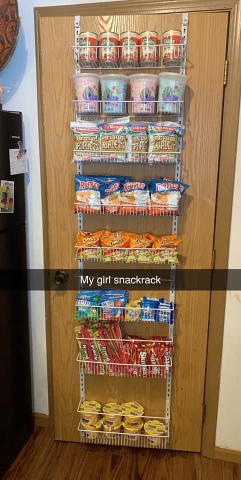 a pantry door is open to show the food on display in it's shelves