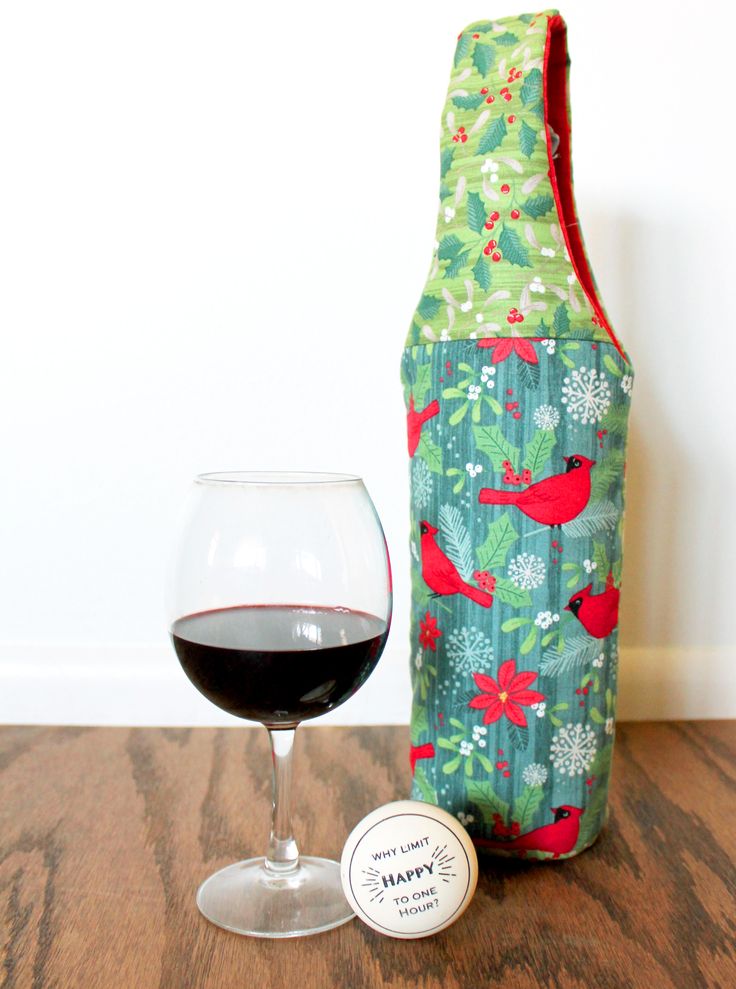 a wine glass and bottle cover sitting on a table