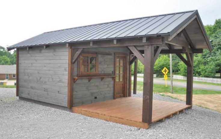 a small wooden building with a metal roof