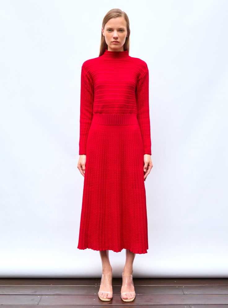 Sublime in motion, this long dress in fine knit knitted in France is slightly fitted at the waist and goes with all silhouettes. From its discreet and elegant waistband unfolds a pleated herringbone knit with a pretty fullness. It is characterized by its high collar and upper body knitted in a subtle and feminine pleated stitch. In "red lacquer" colour, a warm and luminous red, wear this knit dress with black pumps for a sophisticated look or colorful sneakers for a casual modern look. The model Herringbone Knit, Pleated Knit, Colorful Sneakers, Red Lacquer, Baby Jumpsuit, Baby Leggings, Black Pumps, High Collar, Clothing For Women