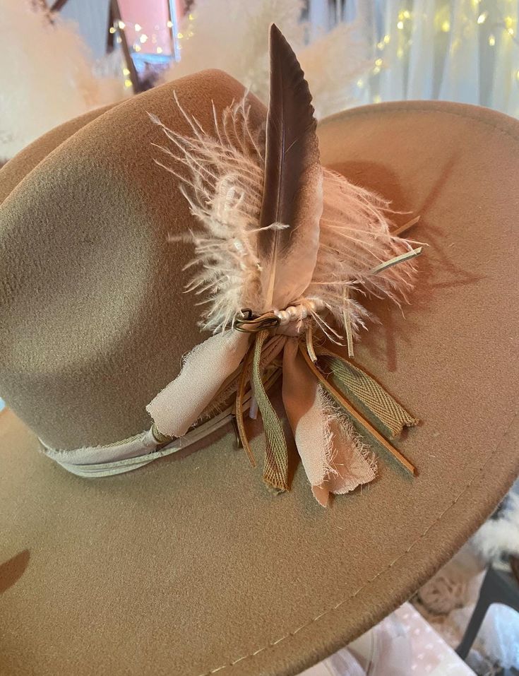 Listing is for one custom, brown hat with bands and feathers as seen in photo and listing.   Hat has adjustable strings on the inside to create the perfect fit. One size fits most.  📦Ready to Ship within 1-3 days  Feathers are unique and may vary.  Some Assembly Required.  Hat ships with band around hat and feathers/florals bundled (if needed/designed) to be inserted or adjusted behind bands upon arrival.  All sales final.  Colors may vary in person from online photos based on device. Small Pieces could be a choking hazard. Keep away from children.  Shipping may occur through any form of USPS or UPS. Brown Top Hat For Kentucky Derby And Country Events, Adjustable Top Hat With Feathers And Wide Brim, Adjustable Brimmed Fedora With Feathers, Adjustable Brown Fedora With Feathers, Adjustable Fedora With Feathers, Brown Wide Brim Top Hat For Country Events, Wide Brim Felt Hat With Feathers For Ranch, Adjustable Brimmed Hat With Feathers, Wide Brim Felt Hat With Feathers For Outdoor