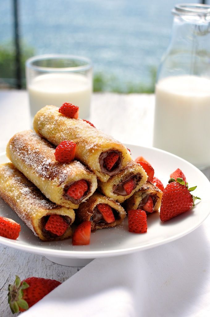 there are many different desserts on the plate and one is filled with strawberries