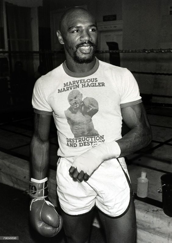 a man in shorts and a t - shirt with a boxing glove on his hand