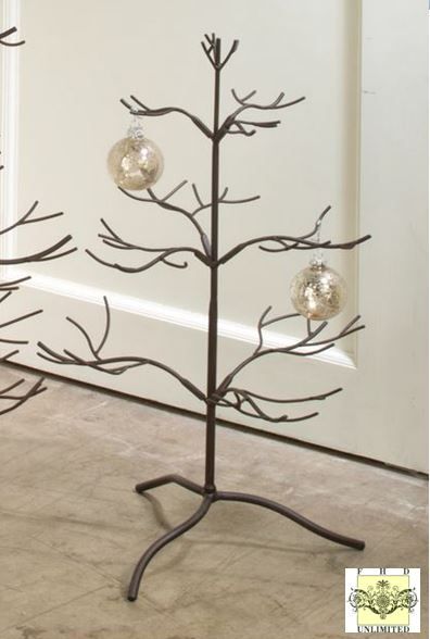 a metal christmas tree with three ornaments on it's branches and two balls hanging from the top