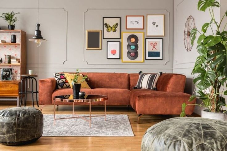 a living room filled with furniture and pictures on the wall