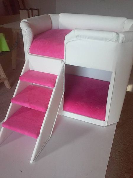 a white chair with pink carpeted steps on it's bottom shelf and stairs up to the top