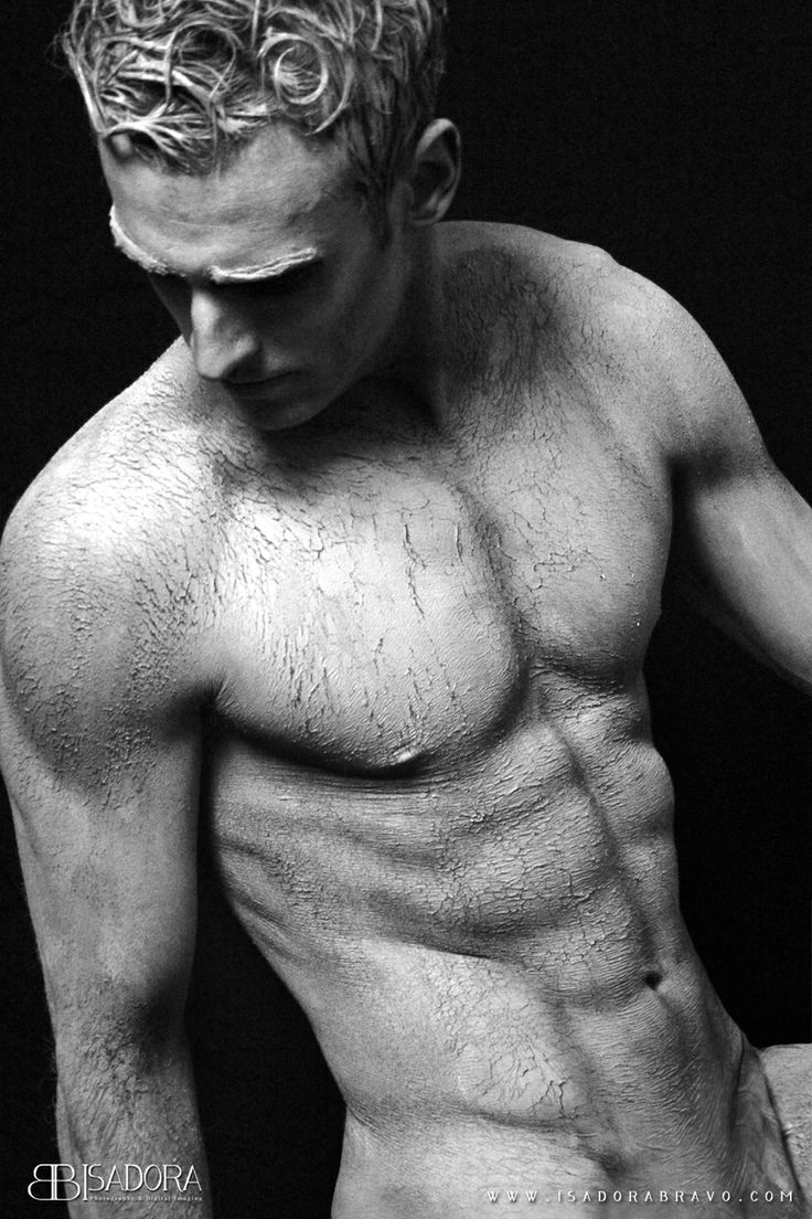 a man with no shirt on posing for a photo in black and white, showing his muscles