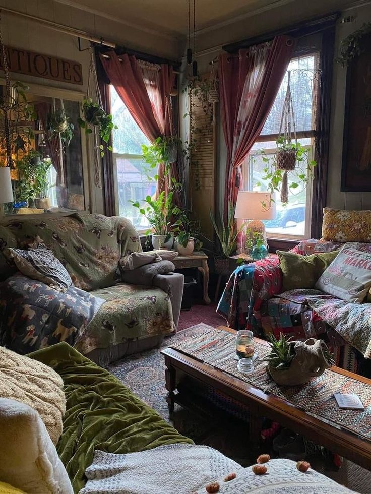 a living room filled with lots of furniture and plants on the windows sills