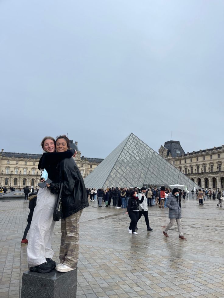 two people standing in front of the pyramid at the musee d'art, paris