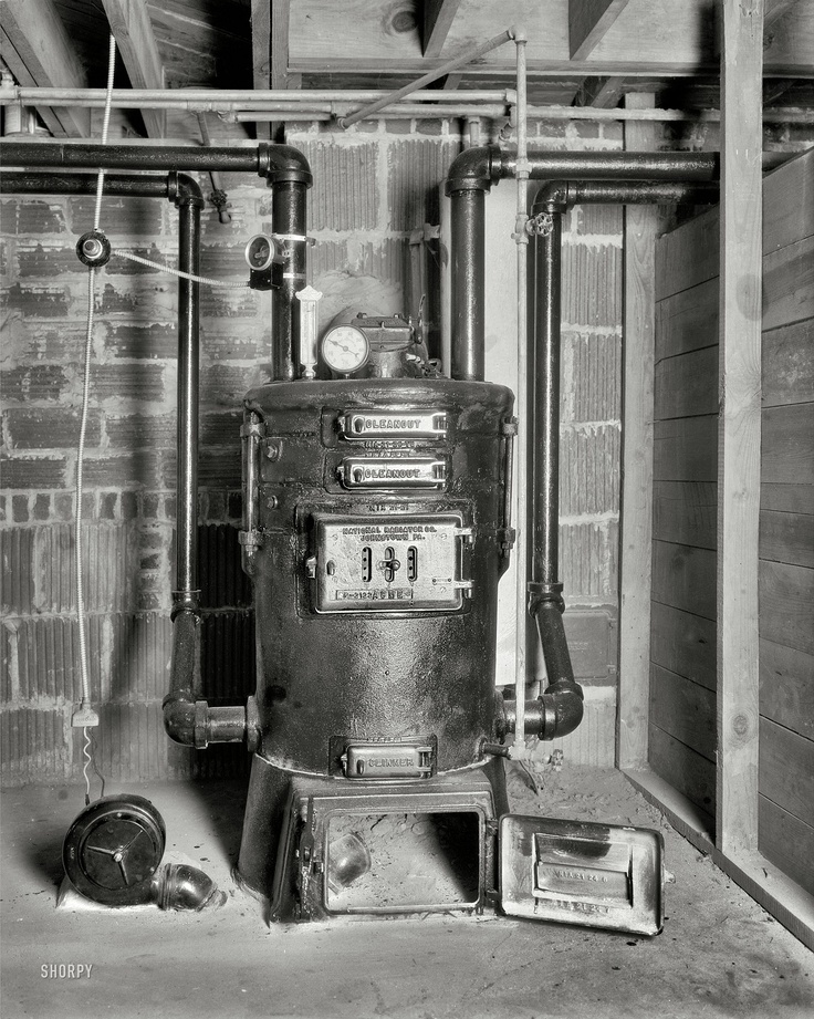 an old fashioned stove and some pipes in a room