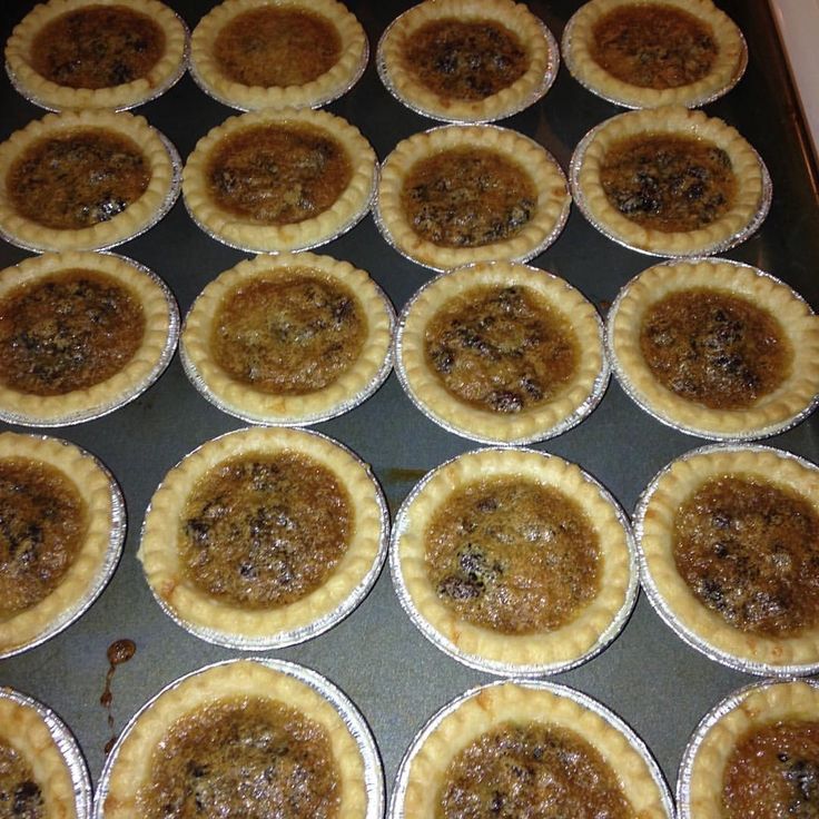 there are many pies on the pan ready to be baked in the oven,