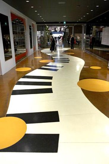 an empty shopping mall with yellow and black circles on the floor