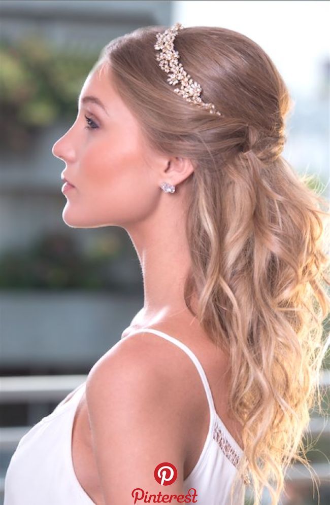 a woman with long blonde hair wearing a white dress and a gold headpiece in her hair