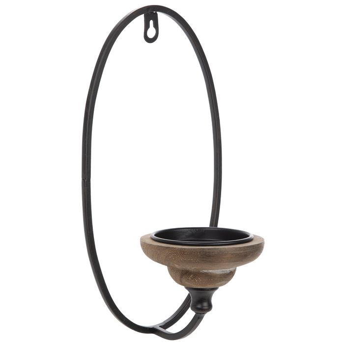 an iron and wood candle holder hanging from a hook on a white background with clippings