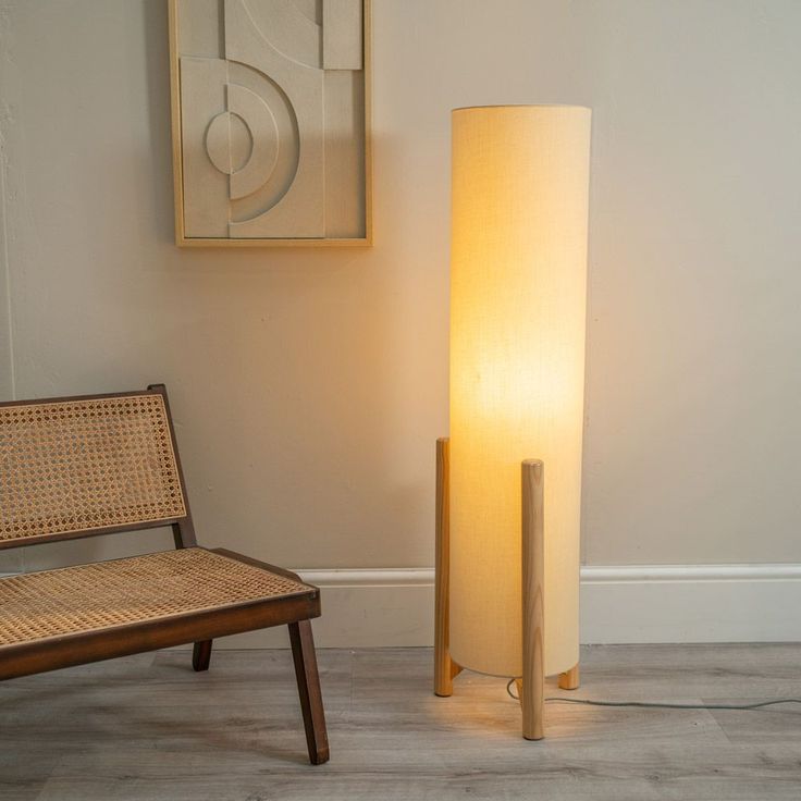 a floor lamp next to a chair in a room