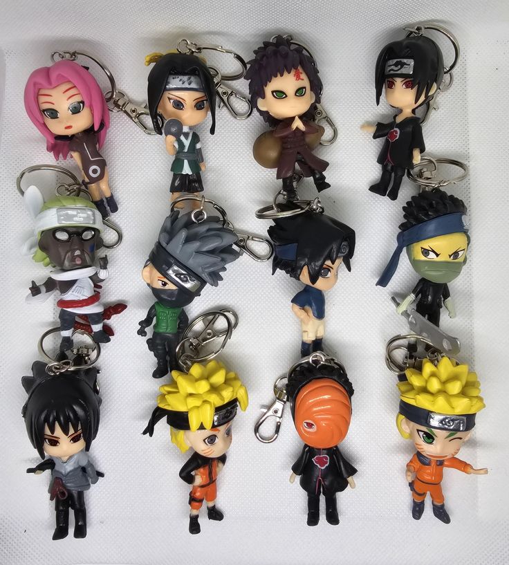 seven keychains with anime characters on them, all in different colors and sizes